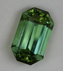 Moderately toned, open ended, green emerald cut