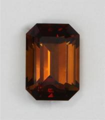 Smaller darker toned, dichroic, mahogany coloed emerald cut.
