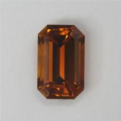 Smaller amber to brown emerald cut.