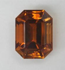 A great, medium dark, slightly burnt orange, emerald cut