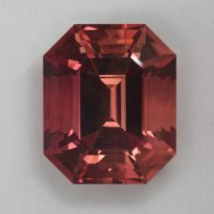A beautiful GEM in pink and orange, emerald cut.