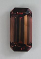 Brown emerald cut with faint flash of maroon.