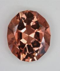 A deeply cut, medium toned, red orange oval.