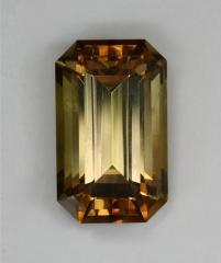 Eye clean, dichroic, slightly green bronzed emerald cut.