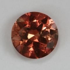 Droplet of color tht mixes pink/yellow in an orange swirl.