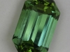 Moderately toned, open ended, green emerald cut