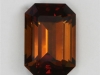 Smaller darker toned, dichroic, mahogany coloed emerald cut.
