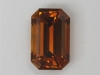 Smaller amber to brown emerald cut.