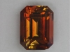 Included dichroic golden red brown emerald cut.