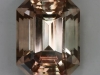 Slightly included pastel peach emerald cut