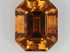 A beautiful yellow orange fully cut emerald cut.