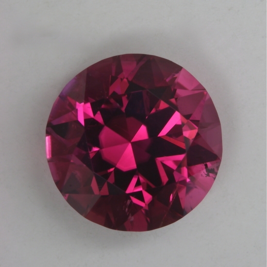 A bit darker than a medium tone, slightly included pink round.  #16