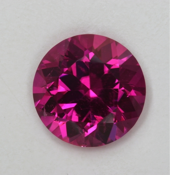 Medium toned hot pink to red round.  #35