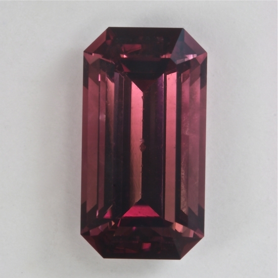 Long ratio maroon colored emerald cut. #501
