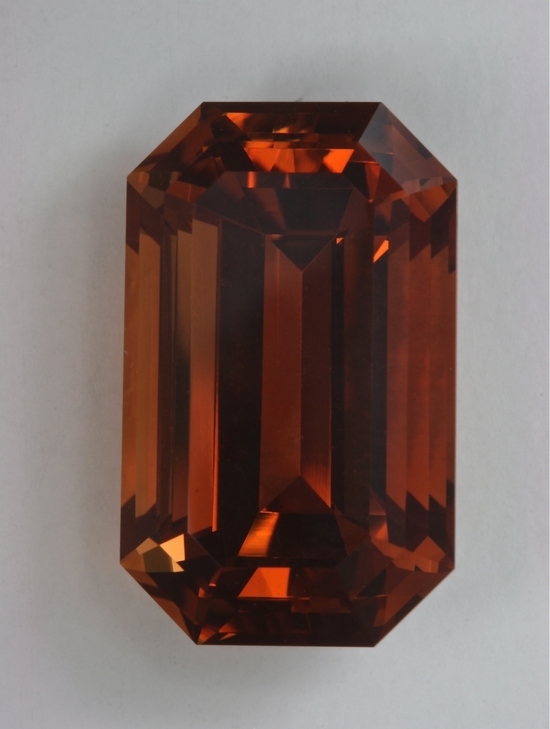 Large, clean, brigh,t rich orange, emerald cut.  #541
