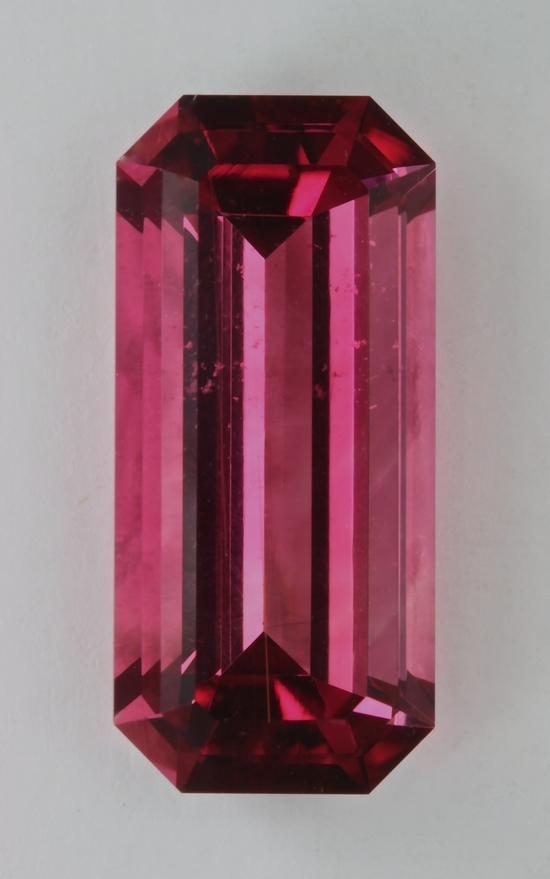 Long ratio bright red emerald cut.  #580