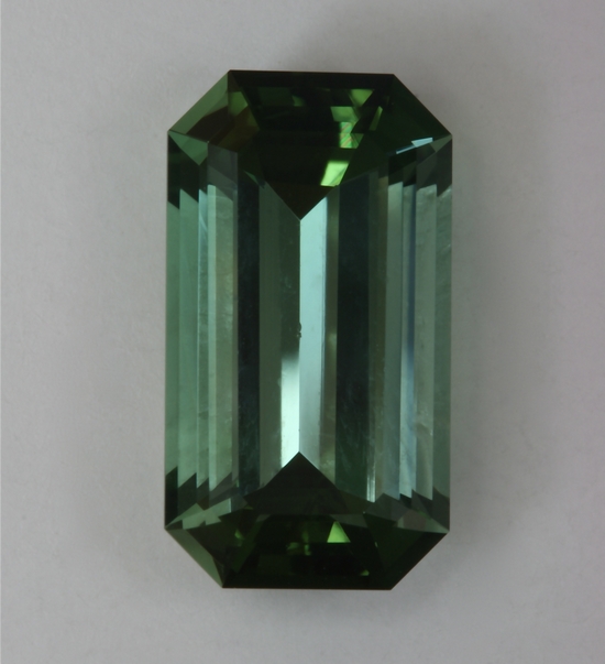 Mildly dichroic, medium toned, highly transparent green emerald cut. #991