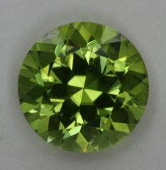 Exceptional yellow green copper bearing round.  #62