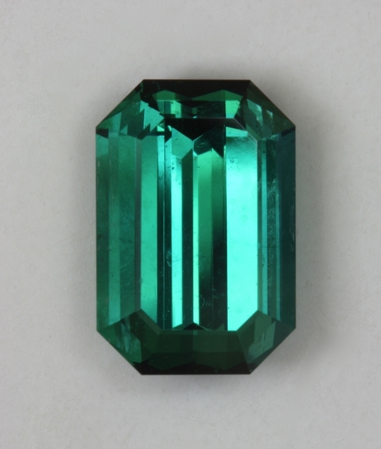 Medium toned, open, blue green emerald cut.