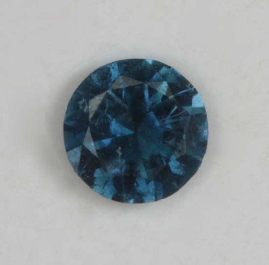 A dark blue dot of color with limited flash.