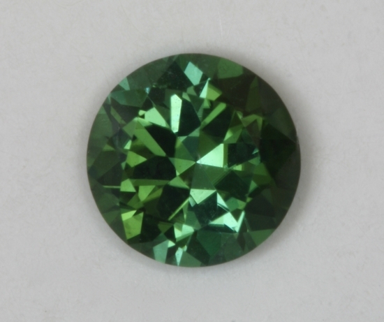 Mixing dichroic colors makes blue green droplet of color.