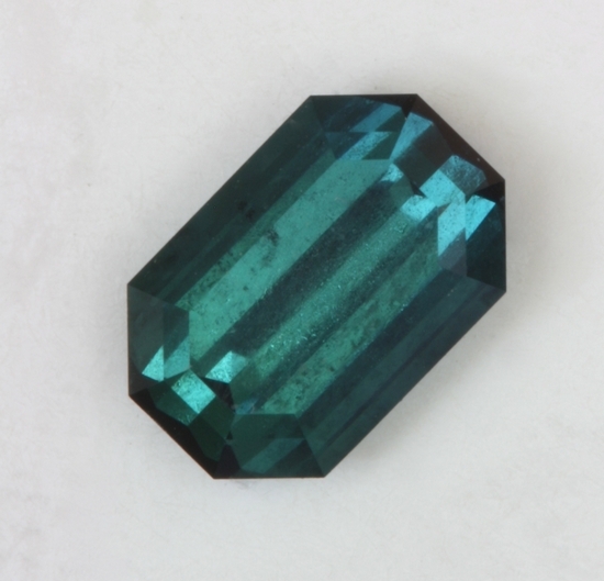 Nice emerald cut with a blue to blue green color.