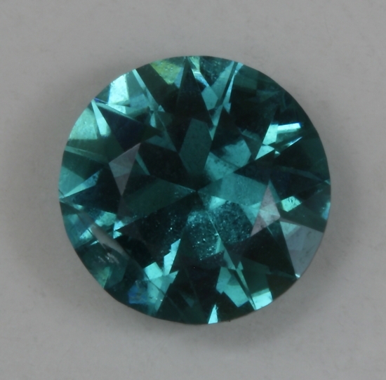 A round with a signifcant white flaw, but great blue color. #143