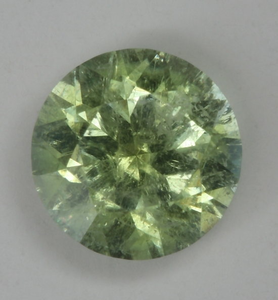 Included, lightly toned yellow green droplet of color.  #152
