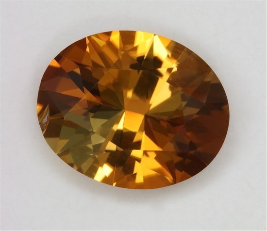Bright, flashing, dichroic paler yellow gold and rich gold, oval  #290