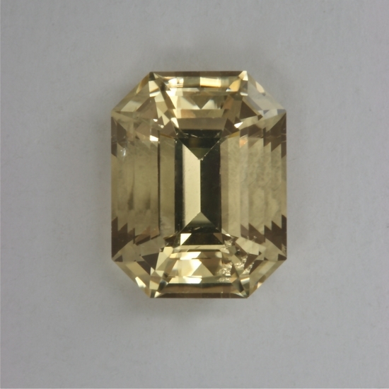 A slightly included pastel yellow emerald cut.  #306