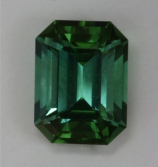 Moderately dichroic emerald cut with darker green ends and bluer sides.  #369