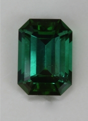 Moderately dichroic blue green emerald cut.  #370
