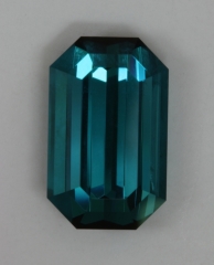 A beautiful blue, with steep ends and lots of flash, emerald cut.  #381