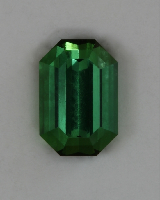 Steeply cut ends on a well saturated green emerald cut.  #405