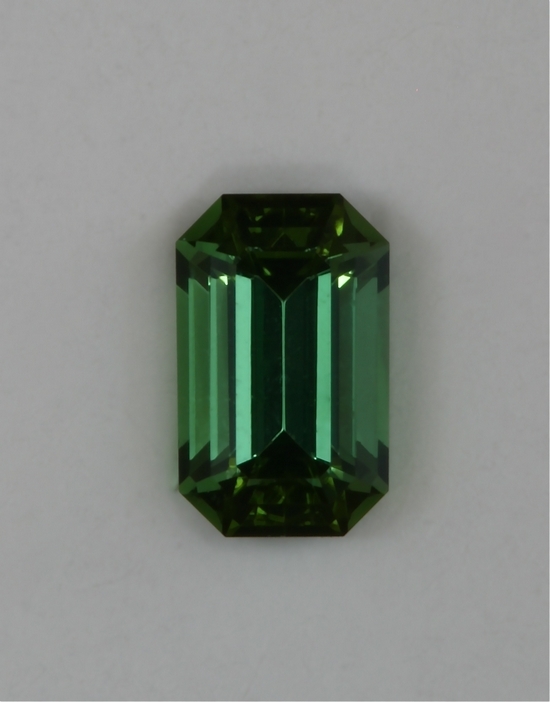 Small open ended well saturated green emerald cut.  #409