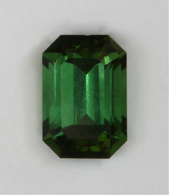 closed ended with normal angles, medium toned, green emerald cut.  #415