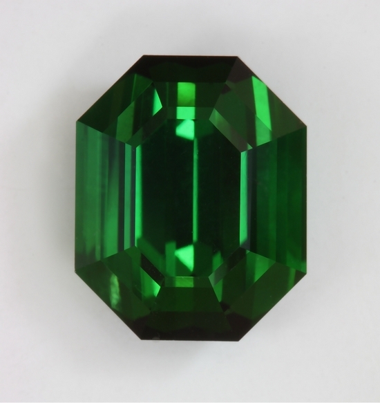 Closed ended, eye clean, flash driven green emerald cut.  #421